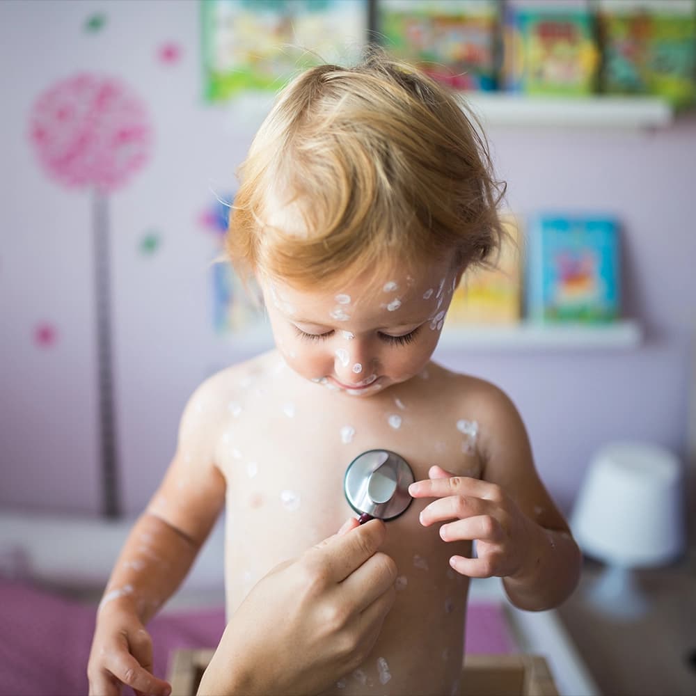 portrait of a baby with cream dots on skin