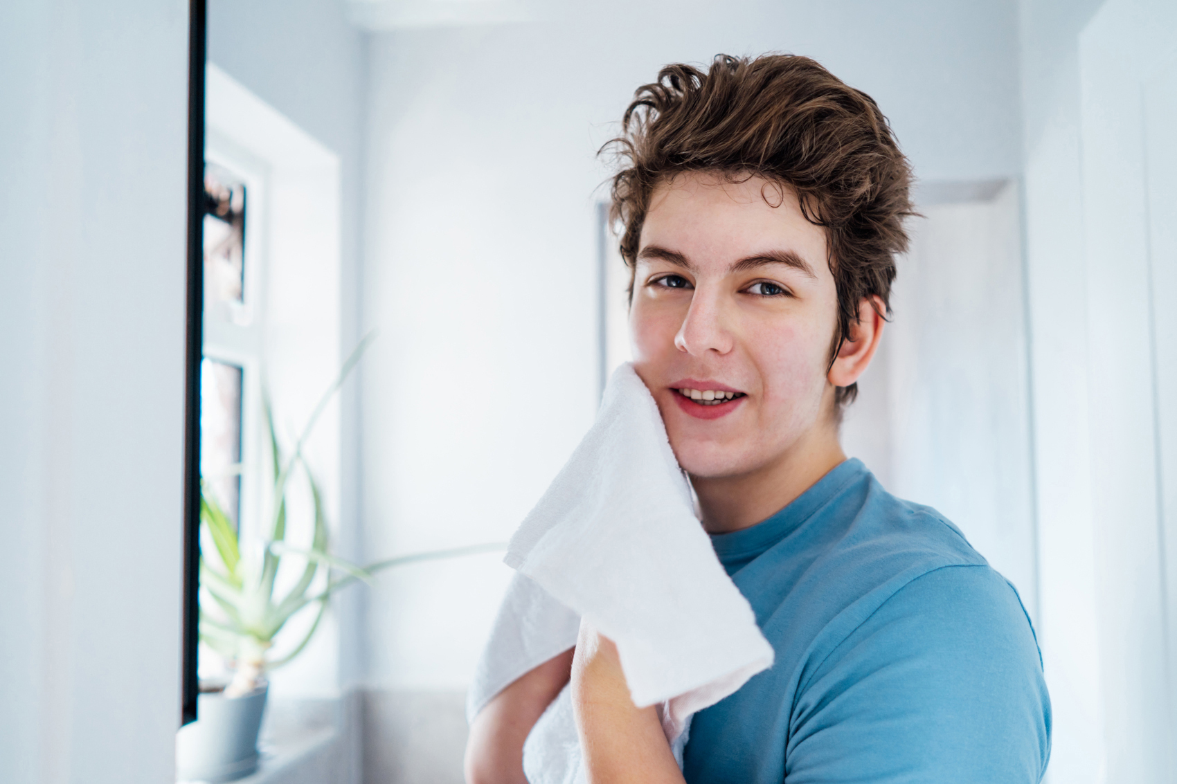 portrait of smiling teenage boy with acne problem
